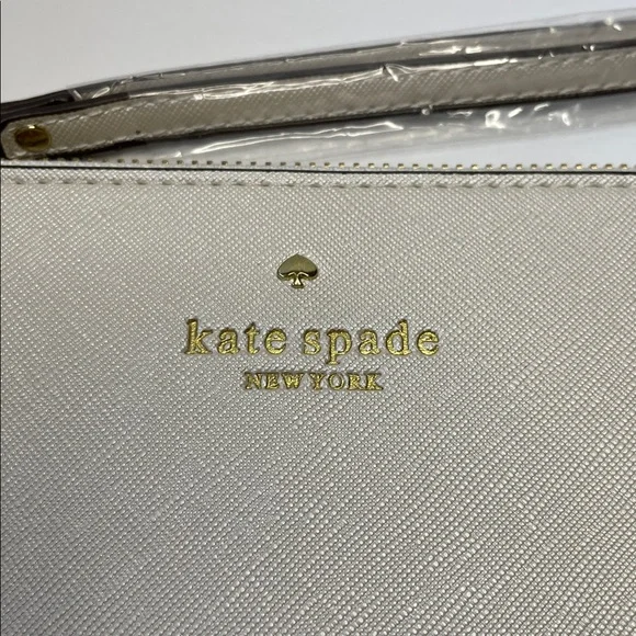 NWT Kate Spade cream saffiano wristlet with gold logo.  8x5” - Picture 2 of 7
